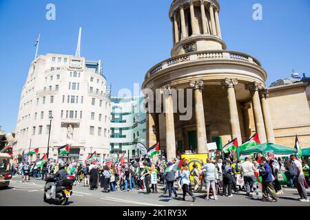 Participants gather during ‘National Demonstration: END APARTHEID – FREE PALESTINE!’ near the BBC Broadcasting House in London. Stock Photo