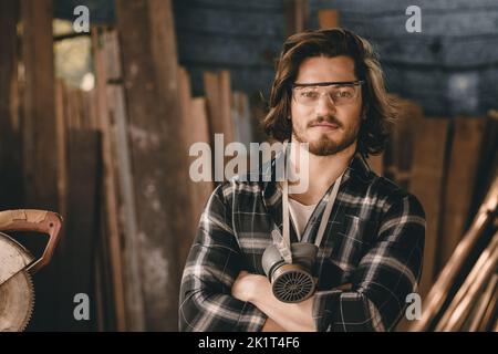 Portrait Carpenter man wood worker builder handsome smart arm crossed looking camera smiling. Stock Photo