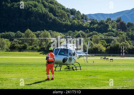 Switzerland, Agno-Lugano Airport, Helicopter on take off Stock Photo