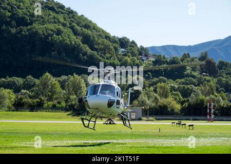 Switzerland, Agno-Lugano Airport, Helicopter on take off Stock Photo