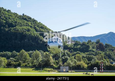 Switzerland, Agno-Lugano Airport, Helicopter on take off Stock Photo