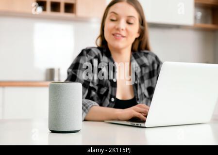 Woman using smart speaker, smart home concept Stock Photo