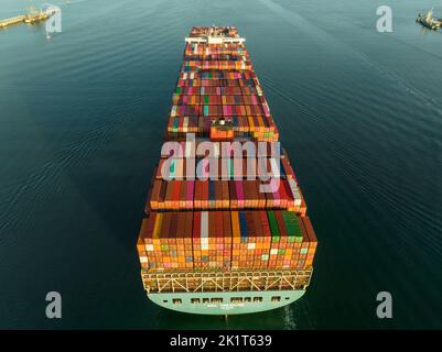 Aerial drone photo of huge container tanker ship mol treasure carrying cargo truck size colourful containers Stock Photo