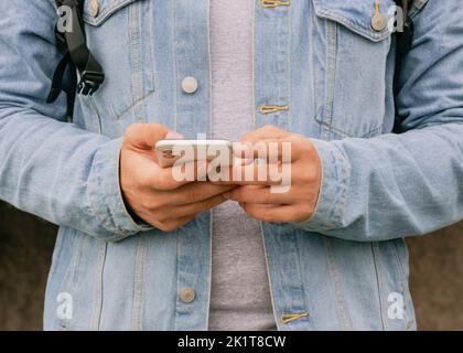 Unrecognizable man texting a message on phone Stock Photo