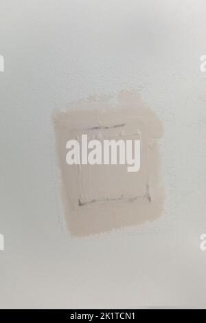 A patch in gray brown greige textured white ceiling of a new construction house Stock Photo