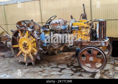 old harvesting rusty tractor agriculture machine without tires Stock Photo