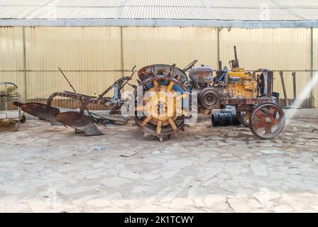 old harvesting rusty tractor agriculture machine without tires Stock Photo