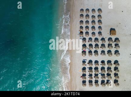 A top view of organized umbrellas on the Albanian coast in Borsh Stock Photo