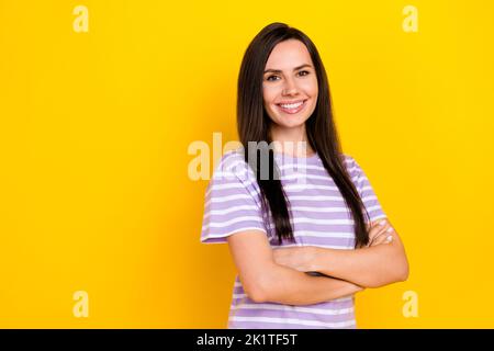 Closeup photo of young attractive nice girl staying folded hands smiling confident ad new cafeteria isolated on yellow color background Stock Photo