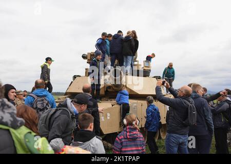 Mosnov, Czech Republic, Czechia - September 17, 2022: Children, kids and civilian people on military show and display. Crowd on the tank from US army. Stock Photo