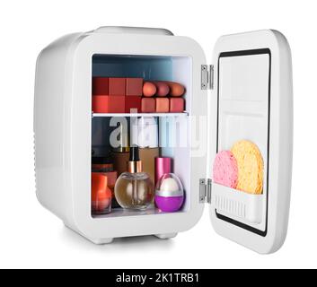 Small refrigerator with cosmetic products on white background Stock Photo