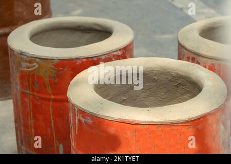 Tradtional Indian DIY Clay Oven Also Called Desi Mitti Ka Tandoor Chulha Bhatti Made Of Mud, Wheat Straw Hay Bhoosa Tin Drum Is Used In Dhaba For Cook Stock Photo