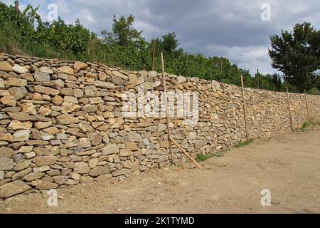 A dry stone wall in a vineyard Stock Photo