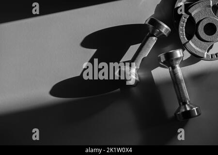 iClose up of dumbbells on grey backgound. Sport and fitness equipment. Horizontal sport poster, greeting cards, headers, website. Stock Photo