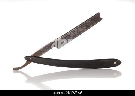Old black razor, vintage shaving blade. Isolated on a white background. Destroyed Stock Photo