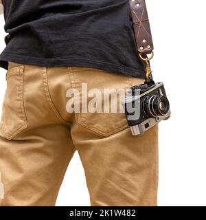 Man is standing backwards with brown hand made natural leather camera shoulder strap isolated on a white background. Photographer equipment, stylish, Stock Photo