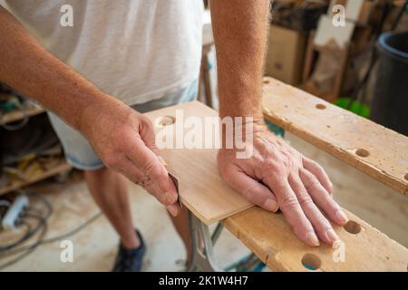 Senior carpenter hands working on wood. DIY maker and carpentry work concept. Stock Photo