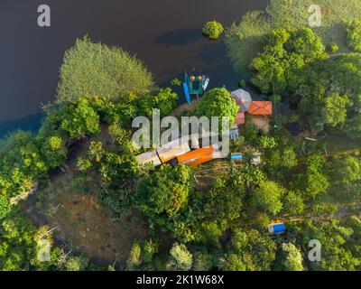 Aerial view of a local guest house in the amazon rainforest with a little pier and small wooden shacks Stock Photo
