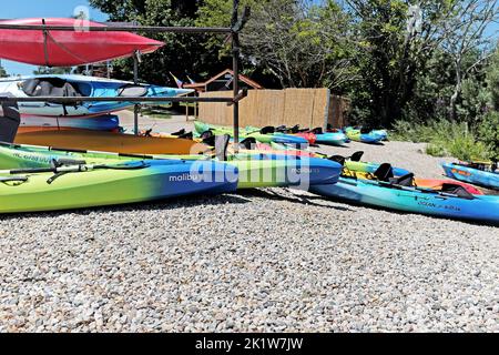 Kayaks on the rocky beachfront in the summer resort town of Douglas, Michigan on July 30, 2022. Stock Photo