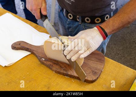 Cutting cheeser in a market Stock Photo