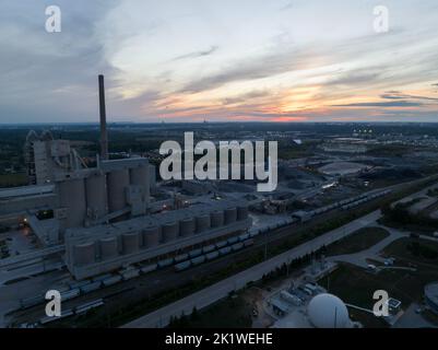 An aerial view looking at a large coal facility at dusk, a beautiful sky in the background. Stock Photo