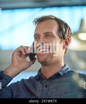 Business is constantly moving. a handsome businessman talking on his mobile phone in the workplace. Stock Photo