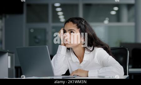 Sad bored lazy young woman typing on laptop tired unmotivated businesswoman office worker feels fatigue from working at computer suffers from overwork Stock Photo