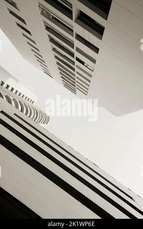 Beautiful high neutral white tower cosmopolitan residential urban condo, condominium, or modern flat buildings structure. Stock Photo