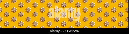 Yellow seamless background. White snowflake pattern. Minimalist symmetrical decorative composition for kids. Cute ornament isolated on bright orange w Stock Photo