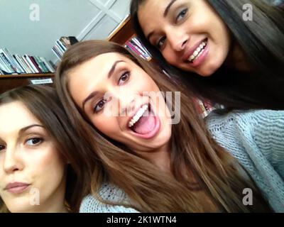 Having the time of their lives. three beautiful young women taking a selfie. Stock Photo