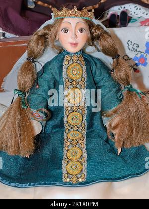 A collectible doll, a princes in the emerald dress, is on display at the Fashion Doll International exhibit in Kiev, Ukraine. Stock Photo