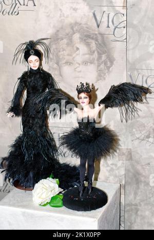 Two collectible dolls, black swan ballet dancers, are on display at the Fashion Doll International exhibit in Kiev, Ukraine. Stock Photo