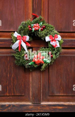 Christmas wreath on the wood red door Stock Photo
