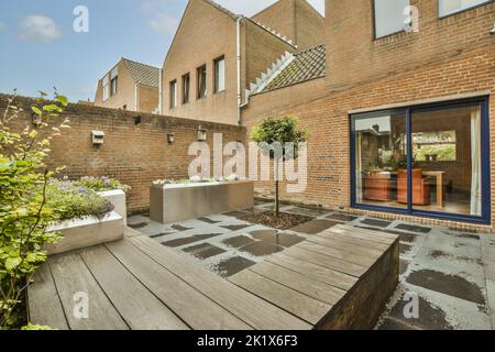 Simple patio with small garden near wooden fence Stock Photo