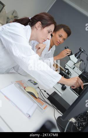 team of scientists in a laboratory working on chemical testing Stock Photo