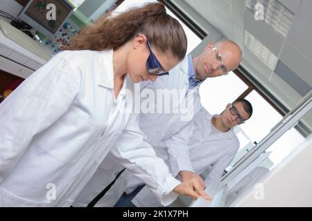 young female scientist doing experiments in lab Stock Photo