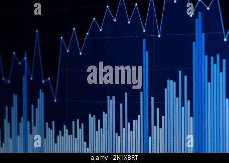 Line chart and bar chart. Close up of a blue chart on a dark background on a led display. Stock Photo