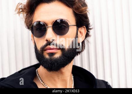 portrait of a young man with beard and sunglasses Stock Photo