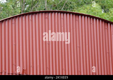 A maroon painted surface of an agricultural barn. Suitable as a background or as an element. Stock Photo