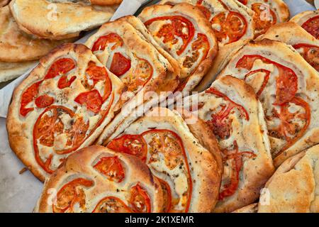 Italian food: traditional focaccia, schiacciata of Tuscany, a flat oven-baked bread product with olive oil and tomato, very popular in Italy. Similar Stock Photo