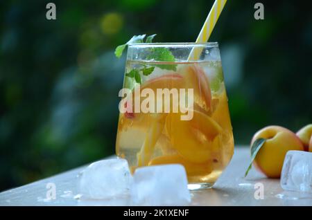 Summer drinks, with mint and peach cocktails with ice in glasses. Refreshing summer homemade Alcoholic or non-alcoholic cocktailsor Detox infused Stock Photo