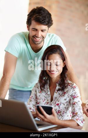 This new technology is amazing. An attractive young couple looking at a digital tablet. Stock Photo