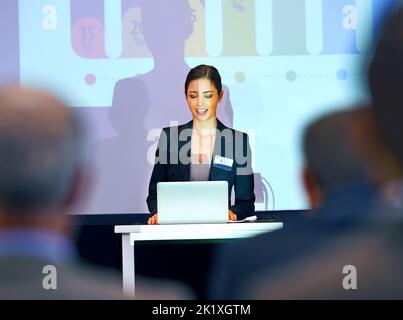 Her first press conference. a group of businesspeople watching a presentation at a conference. Stock Photo