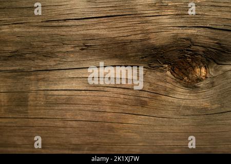 Close-up of weathered wood showing a knot from the tree it came from, ideal natural-looking background for illustrating natural themes Stock Photo