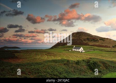 Mwnt is a secluded cove on the ceredigion coast above a beautiful beach is the 14th century Holly cross church Stock Photo