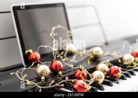 Piano keys with Christmas decorations, closeup Stock Photo