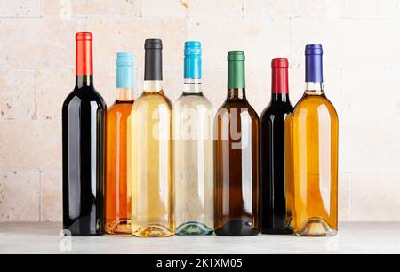 Various wine bottles on stone table Stock Photo