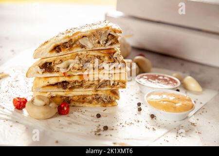 Beef tenderlion steak and mushroom stuffed naan bread calzone quesadilla. Stock Photo