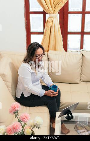 Older woman at home reading on a tablet Stock Photo