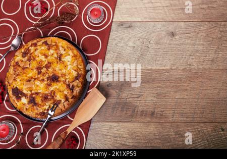 Homemade yellow plum pie on rustic background, top view, copy space. Classic autumn Thanksgiving dessert - organic pie Stock Photo
